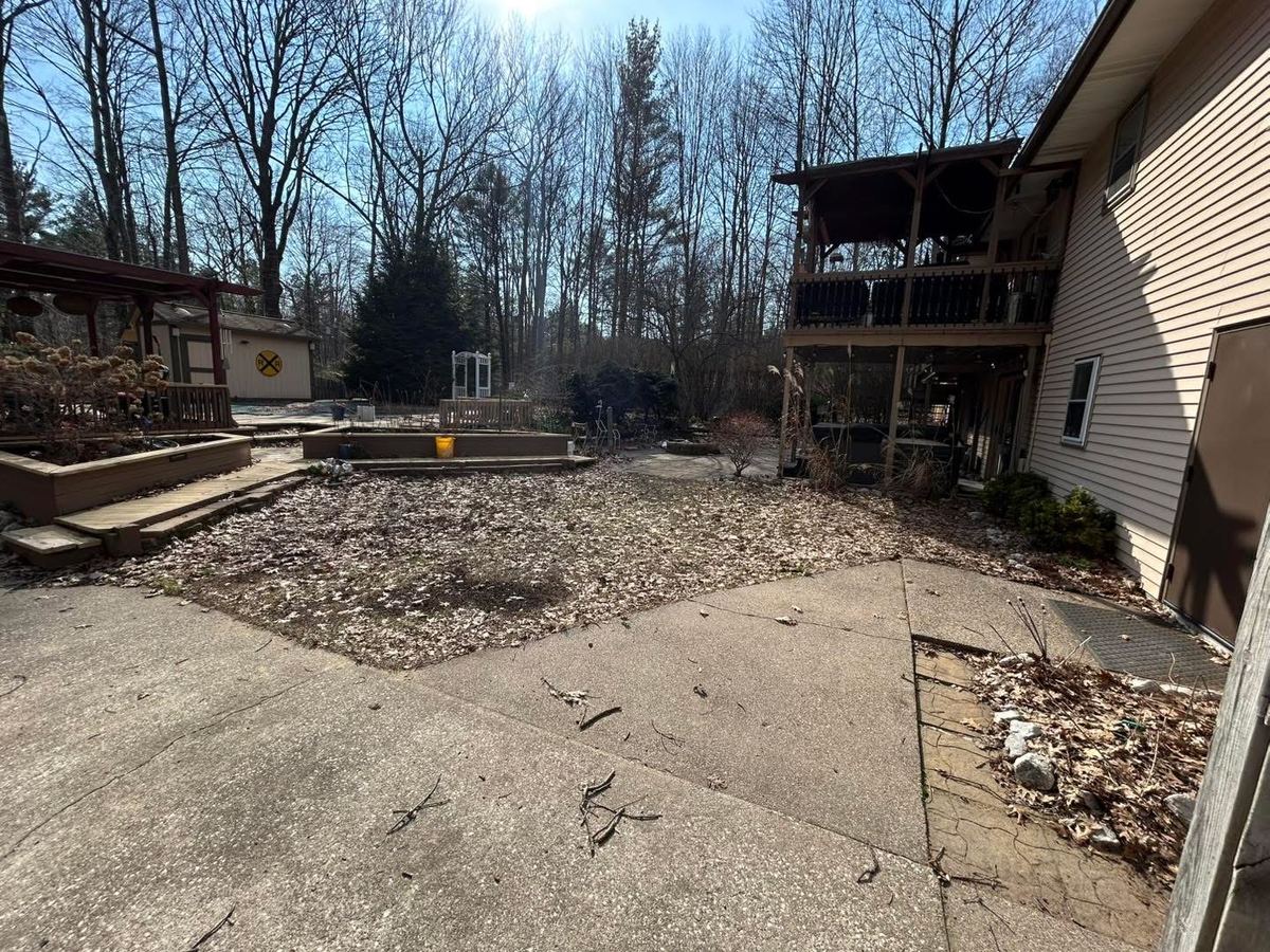 Before — deck and backyard lawn covered in leaves and debris