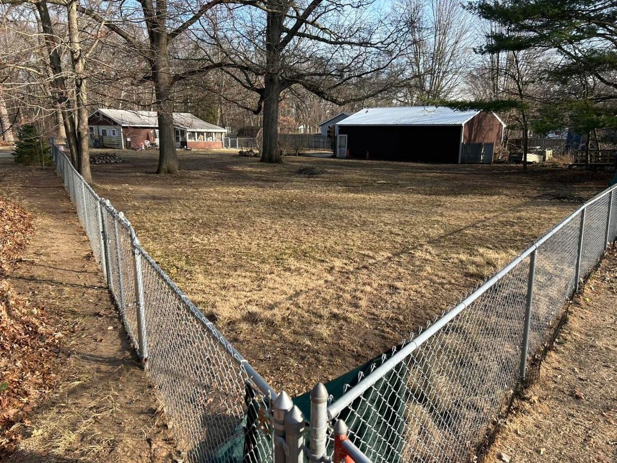 After — fence line cleared of leaves