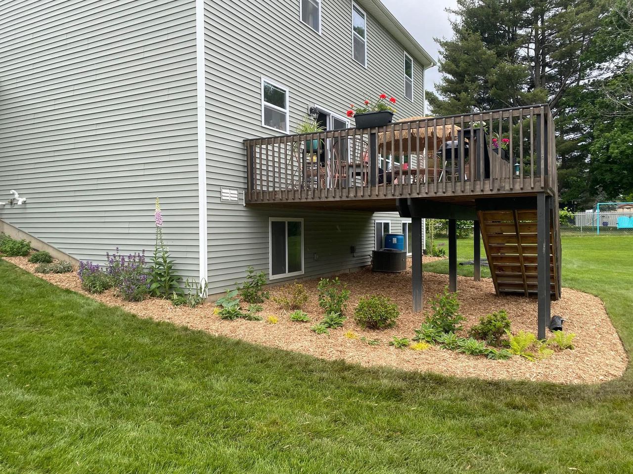 After — fresh mulched garden bed beside the deck