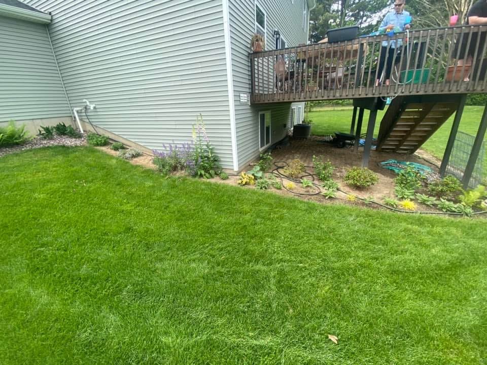 Before — deck-side garden bed before mulching