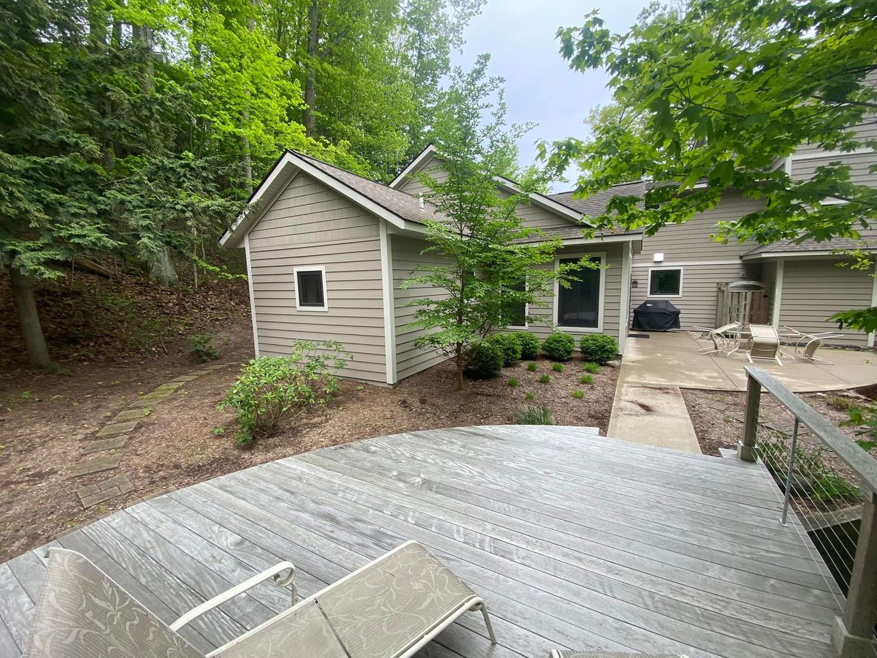 Before — patio area overgrown and cluttered